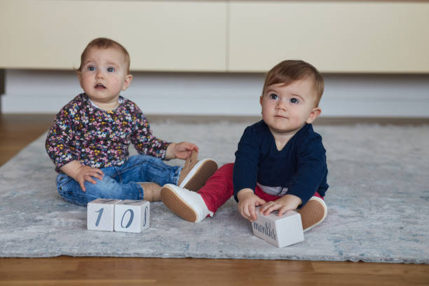 Beautiful twin sisters having 10 months.