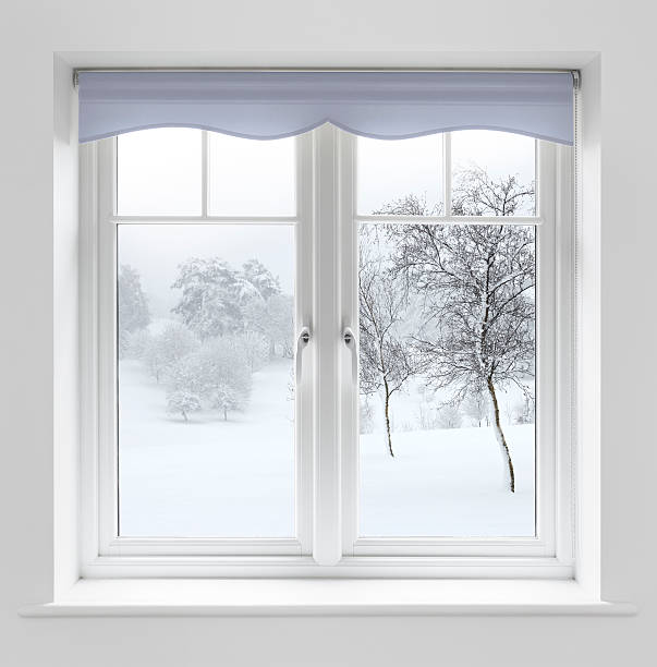 Winter view through white windows A set of fine white double glazed wooden windows with a powder blue roller blind above. The view is to an immaculate snow covered garden and fields with trees in the foreground and misty trees in the background. A clipping path has been provided to enable the blind colour (Hue) to be easily chaged if required. window latch stock pictures, royalty-free photos & images