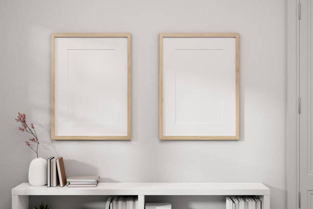 istock Two picture frames mockup on a white wall and a white bookcase in a white minimal room. 1866692887