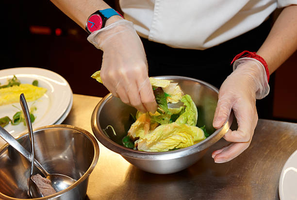 istock Chef is mixing salad at professional kitchen 186669704