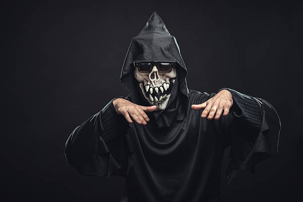 istock skeleton in a black robe with glasses dancing 186669838