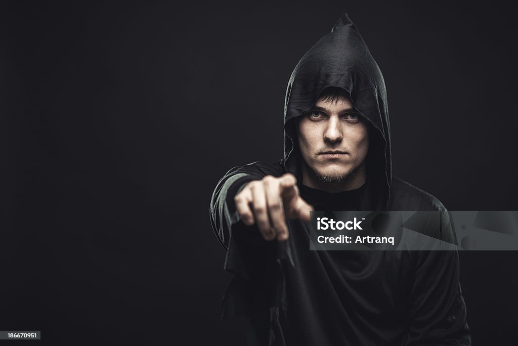guy in the black robe indicates you the guy in the black robe indicates you Adult Stock Photo