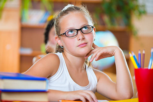 istock Cute girl in classroom at school 186671236