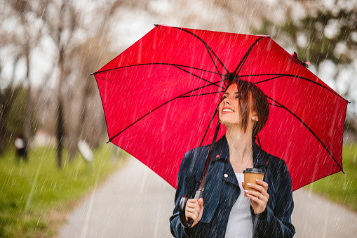 hand holding an umbrella on isolated white background