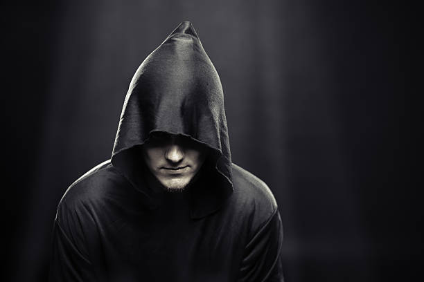 istock guy in a black robe under rays of the moon 186673257