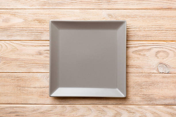 istock Top view of empty square plate on wooden background. Empty space for your design 1866732890
