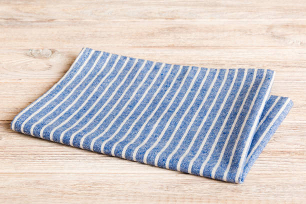 istock top view with blue kitchen napkin isolated on table background. Folded cloth for mockup with copy space, Flat lay. Minimal style 1866733462