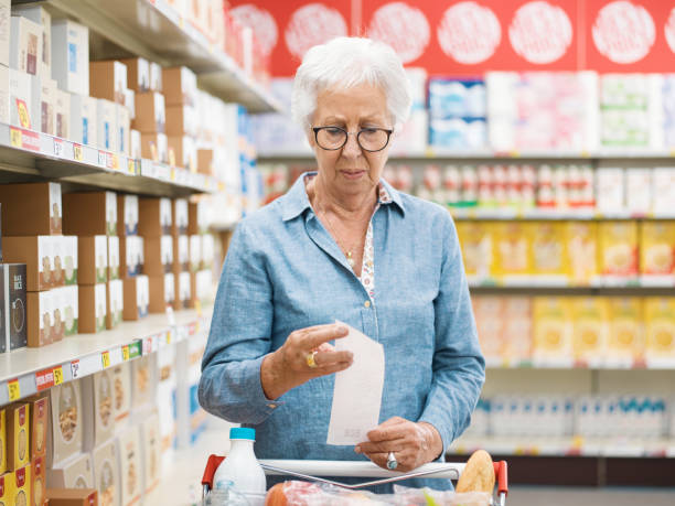istock Disappointed senior customer checking the grocery receipt 1866745743