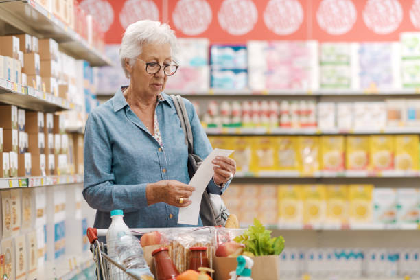 istock Disappointed senior customer checking the grocery receipt 1866754303
