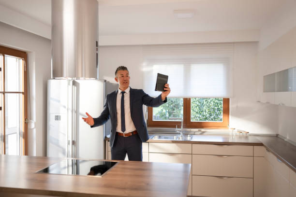istock Real estate agent showing luxury house on digital tablet 1866755418