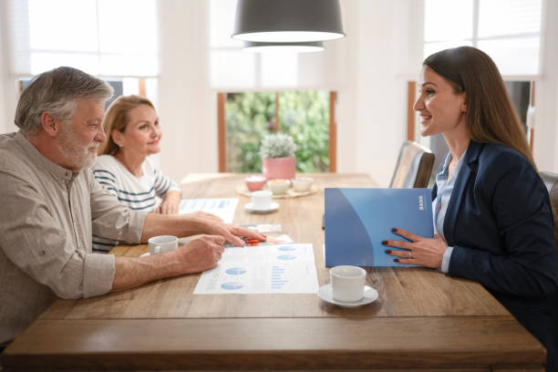 istock Senior couple talking with financial advisor 1866758032