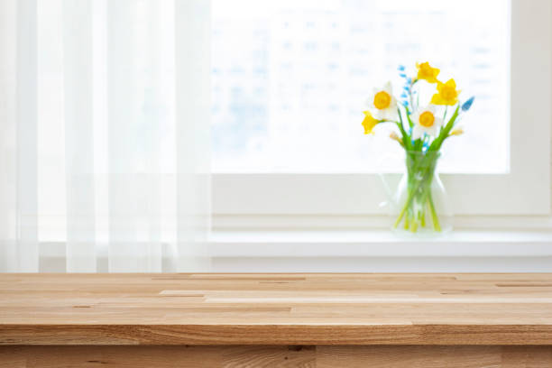 Empty wooden table top for product montage and blur window sill with beautiful flowers Empty wooden table top for product montage and blur window sill with beautiful flowers Transparent Wood stock pictures, royalty-free photos & images