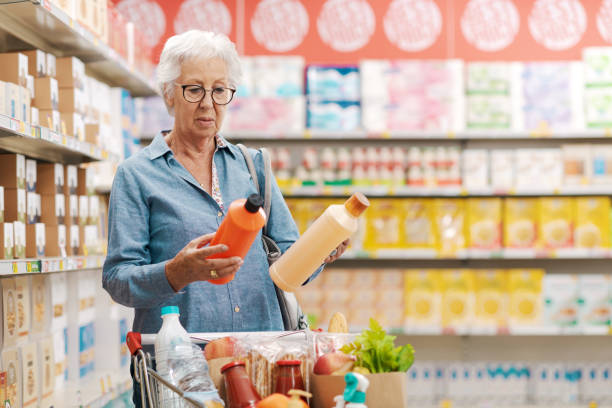 istock Senior customer comparing products at the supermarket 1866764763