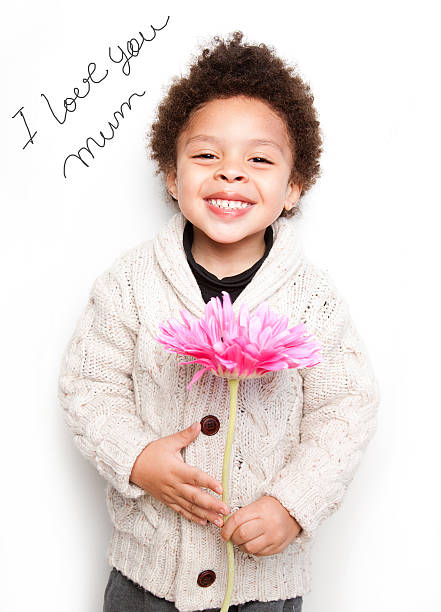 istock Child smiling with pink flower and love mum message 186676619