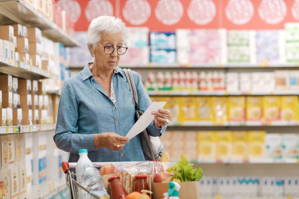 istock Disappointed senior customer checking the grocery receipt 1866768374