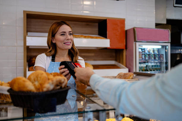 istock Man paying with credit card in bakery 1866769453