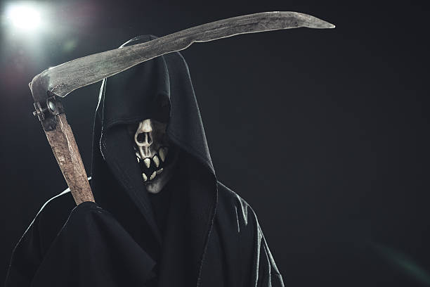 istock death with scythe standing in the dark 186677264