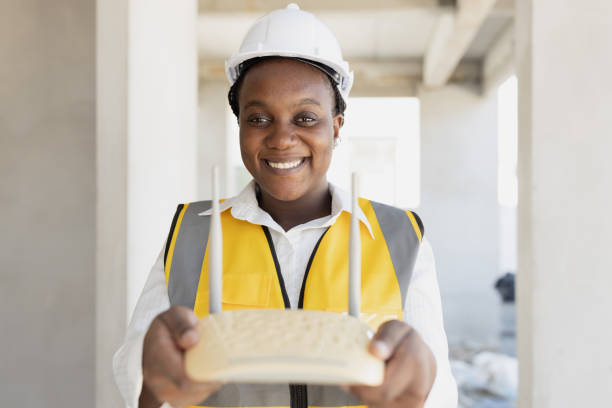 istock Network engineer hand holding wireless wifi access point internet router happy smiling for professional setup install right position home networking concept. 1866780993