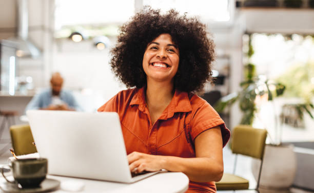 istock Female nomad working on a laptop in a coffee house 1866782096