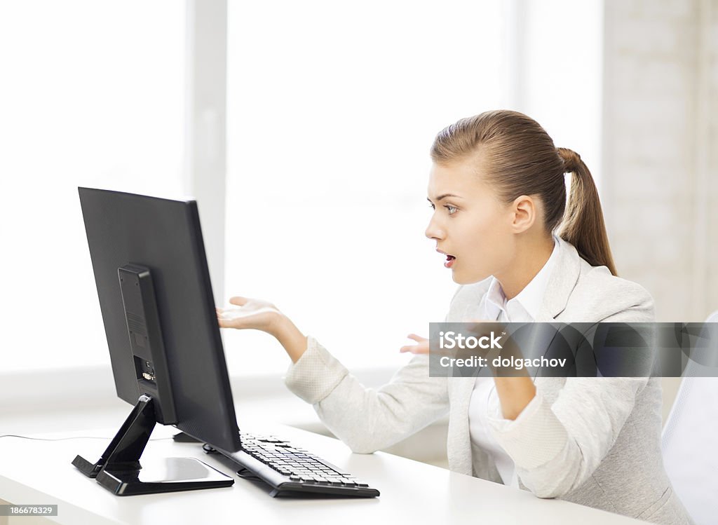 stressed student with computer in office picture of stressed student with computer in office Adult Stock Photo
