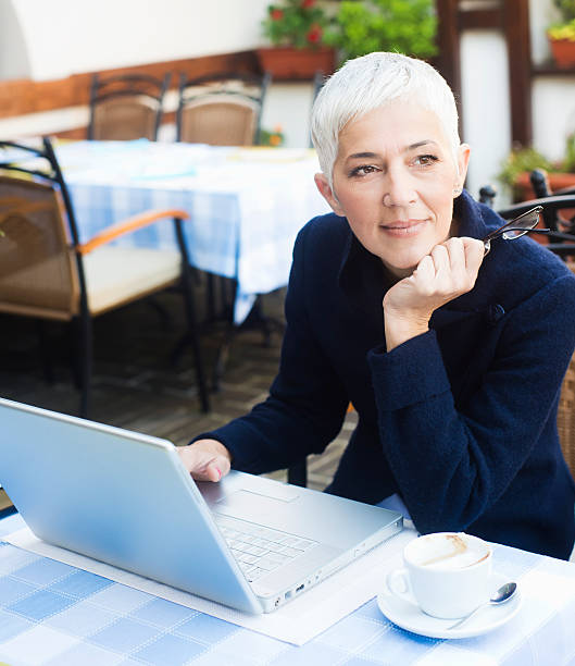 istock Mature woman working at caffe 186678867