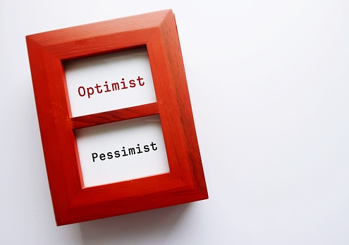 Photo frame on copy space background with text written OPTIMIST and PESSIMIST - concept of choose having optimistic positive mindset or pessimistic negative thinking