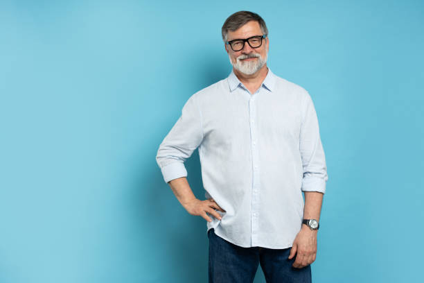 istock Bearded middle-aged man wearing glasses posing over blue studio background 1866802612
