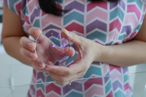 Woman fortune telling with glass sphere. Smiling and gesturing