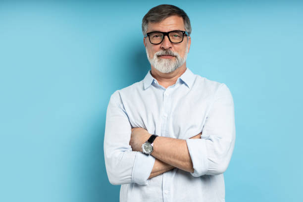 istock Bearded middle-aged man wearing glasses posing over blue studio background 1866813700