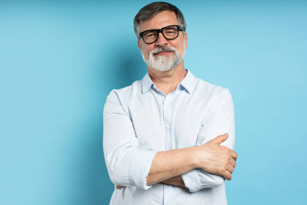 istock Bearded middle-aged man wearing glasses posing over blue studio background 1866813709