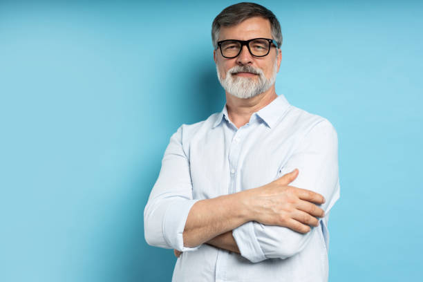 istock Bearded middle-aged man wearing glasses posing over blue studio background 1866813710
