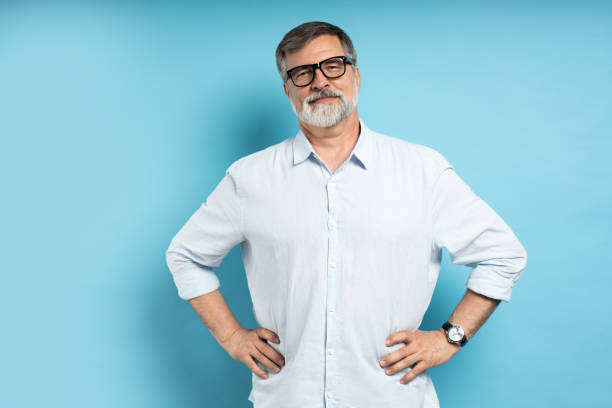 istock Bearded middle-aged man wearing glasses posing over blue studio background 1866813712