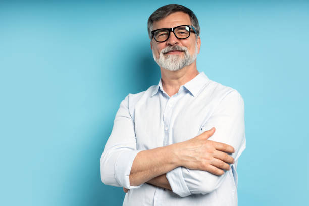 istock Bearded middle-aged man wearing glasses posing over blue studio background 1866813713
