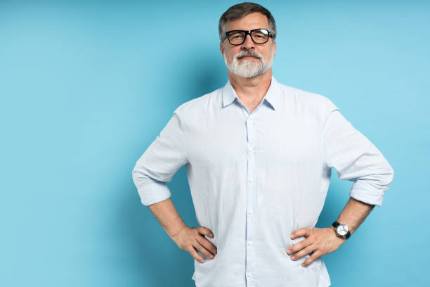 istock Bearded middle-aged man wearing glasses posing over blue studio background 1866813716