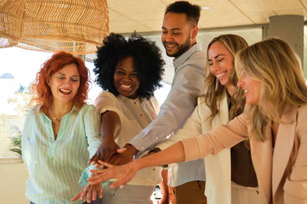 istock Smiling team of multiethnic businesspeople stack hands in a coworking office. 1866816856