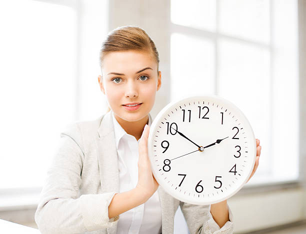 istock attractive businesswoman showing white clock 186682101