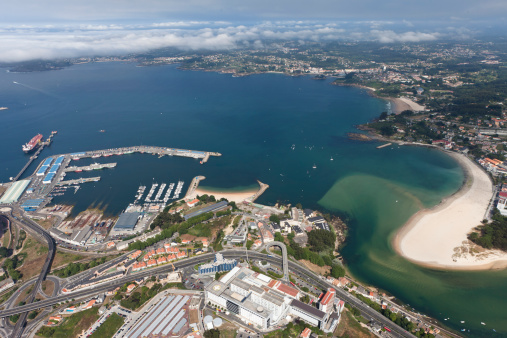 Aerial view of A Coruña Port and the coast with the beaches of Coruña and Oleiros.