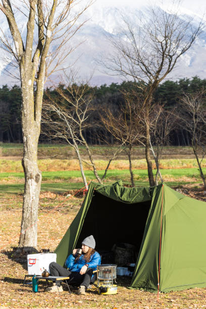 istock Man relaxing outside his tent with a morning coffee 1866829498