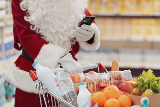 istock Santa Claus using a smartphone at the supermarket 1866830019