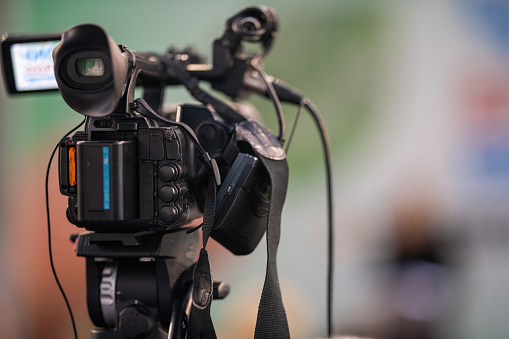 Media camera stands on an event, capturing every key moment and nuanced expression