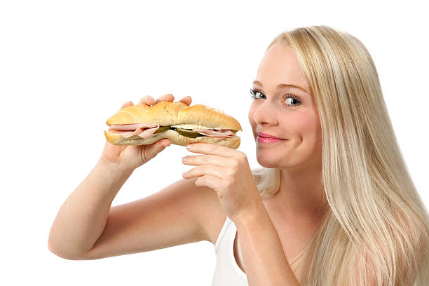 istock Young woman eating sandwich 186683381