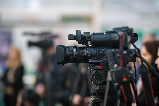 Media cameras focuses on capturing the vibrant pulse of a buzzing media event