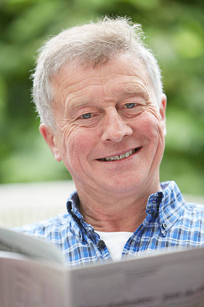 istock Senior Man Reading Newspaper At Home 186683463