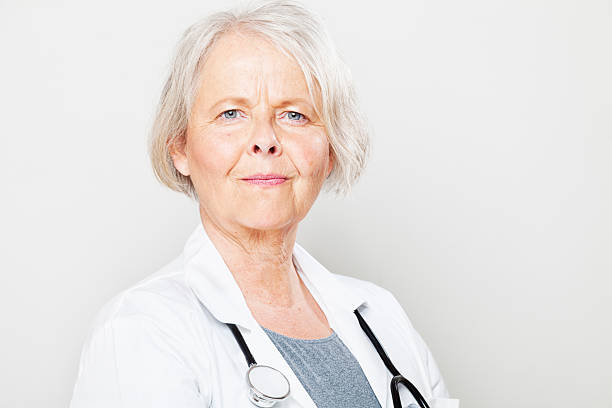 istock senior woman doctor smile 186683475