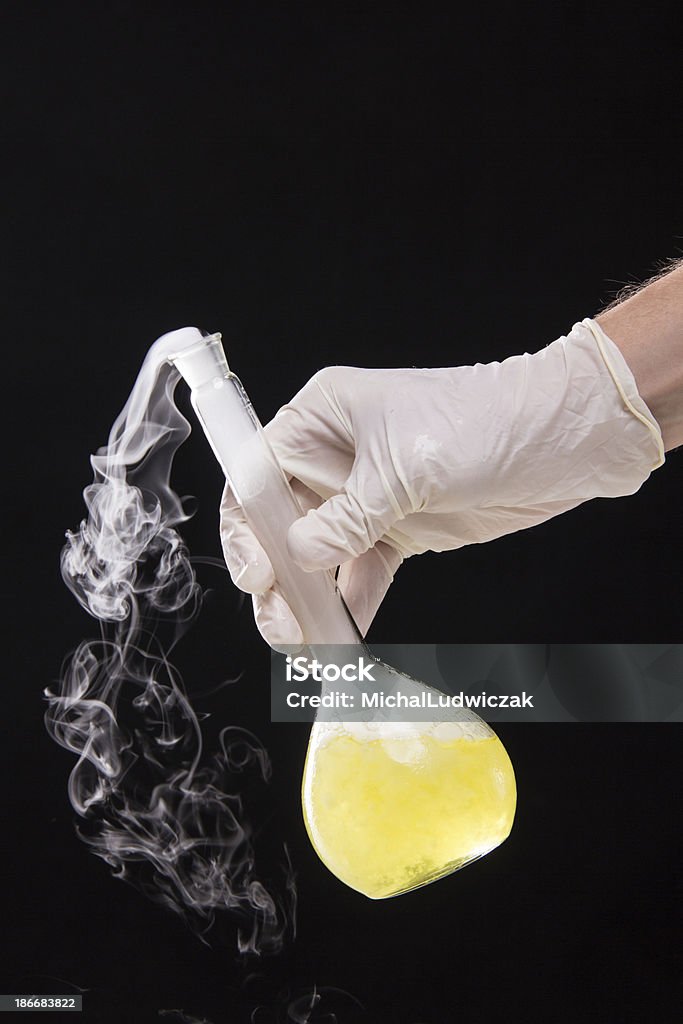 Chemist Hand The chemical reaction in the laboratory glass Chemical Reaction Stock Photo