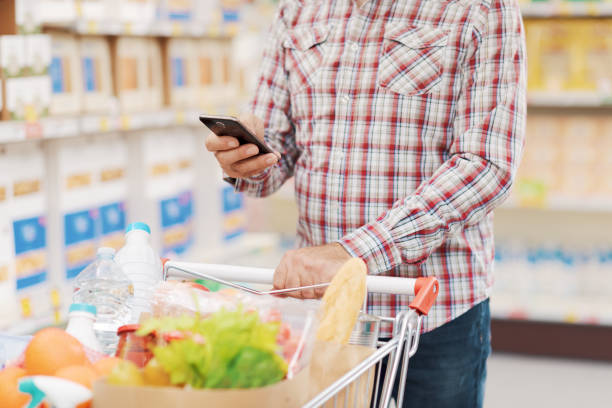 istock Customer using a smartphone at the supermarket 1866838362