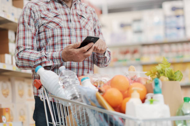 istock Customer using a smartphone at the supermarket 1866839954