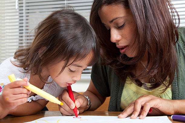 istock Mother and daughter coloring 186684095