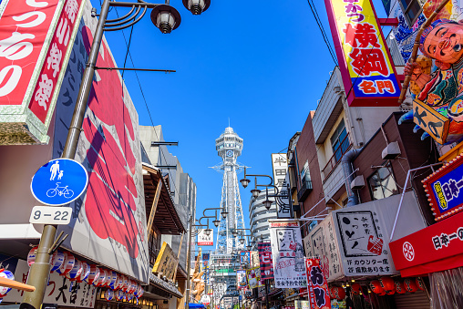 Osaka,Japan - November 22 2023: Shinsekai district of Osaka with Tsutenkaku tower, a landmark tower of Osaka and registered as a national tangible cultural property.
