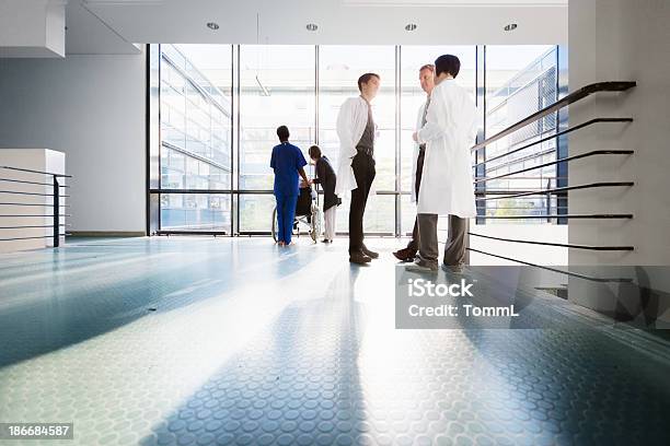 Doctors In Corridor Stock Photo - Download Image Now - Hospital, Doctor, Corridor